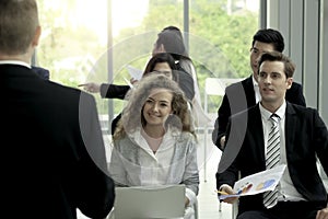 Group of business people sitting on conference together listening to the speaker giving a speech in the meeting room seminar  The