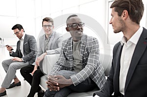 group of business people sitting in the office corridor