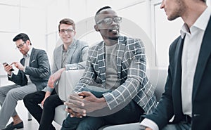 group of business people sitting in the office corridor