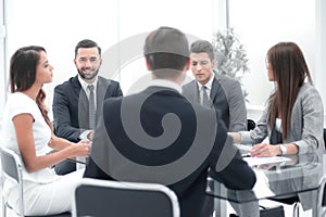 group of business people sitting at a table at an office working meeting