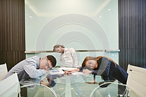 Group of business people sleeping in meeting room with blank pic