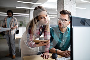 Group of business people and software developers working as a team in office