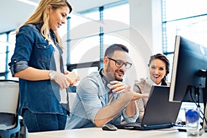 Group of business people and software developers working as a team in office photo