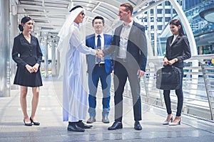 Group of business people standing and skaking hand in the city for success in business dealings. multi culture of business people photo