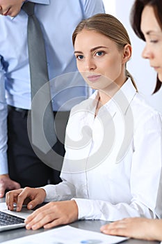 Group of business people using laptop computer in office. Meeting and teamwork concept