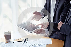 Group of business people using tablet computer in office