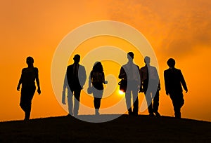 Group of Business People Walking in Back Lit