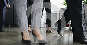 Group of business people walking in corridor of modern office building bottom view, team of successful businessmen and