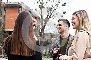 Group of business people walking outside in front of office building. Colleagues discussing on the way to the work. Young