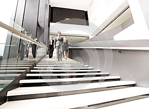 Group of business people walking at stairs