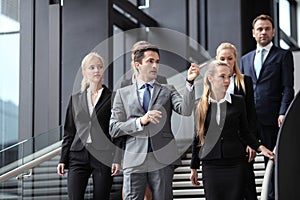 Group of business people walking at stairs