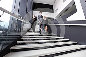 Group of business people walking at stairs