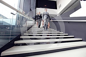 Group of business people walking at stairs