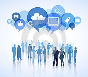 Group of Business People In A White Background With Colorful Speech Bubbles Above Containing Social Networking Symbols photo