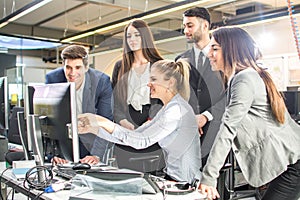 Group of business people working around computer.