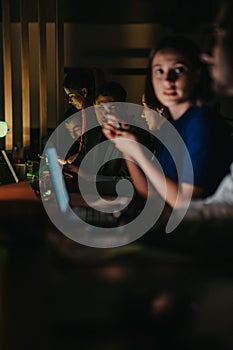 Business team collaborating at night to meet important project deadline photo