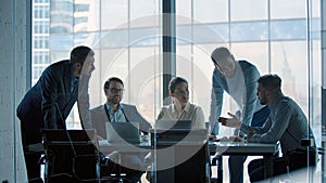 Group of business people working at a table at meeting room. Mature business people working with laptop