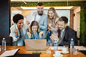 Group of business people working together on a laptop