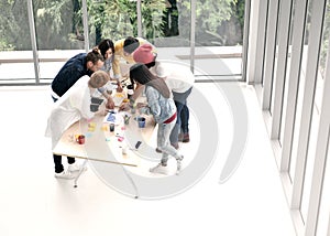 Group of business persons standing around a desk