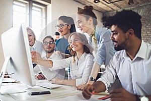 Group of business professionals having a meeting. Diverse group of designers smiling at the office.