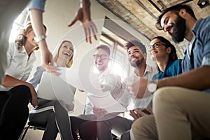 Group of business professionals having a meeting. Diverse group of designers smiling at the office.