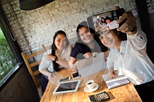 Group of business woman taking selfie in cafe