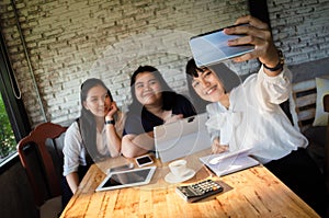 Group of business woman taking selfie in cafe