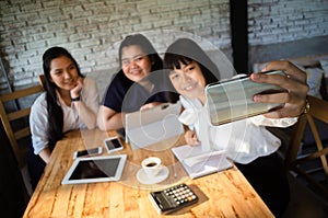 Group of business woman taking selfie in cafe