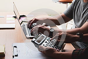 Group businessman hand using calculator Calculating bonusOr other compensation to employees to increase productivity.Writing