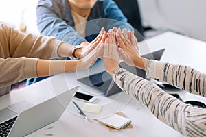 Group of businessman putting their hands together