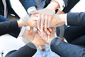 Group of businessman team touching hands together. Selective focus.