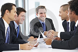 Group Of Businessmen Having Meeting In Office