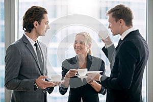 Group of businessmen having tea after meeting