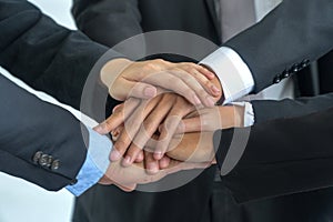 Group businessmen holding hands after of the meeting success. Businessman team joining hands together Concept of