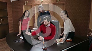 A group of businessmen meeting with laptop in modern office.