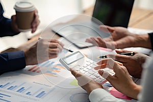 Group businessmen point to the material for the meeting, working together to plan to develop and solve common business problems.