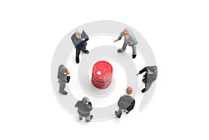 A group of businessmen standing in the circle of red drums isolated on white background and discuss on the strategy of business