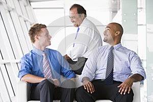 Group of businessmen talking in lobby