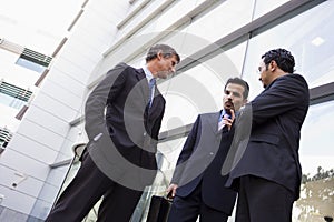 Group of businessmen talking outside office