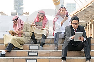 Group of businessmen watching the tablet of their own interests and do not talk to each other in a modern city. young man