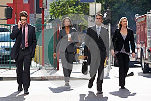 Group Of Businesspeople Crossing Street