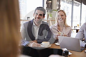 Group Of Businesspeople Having Meeting In Coffee Shop