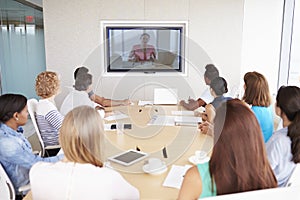 Group Of Businesspeople Having Video Conference In Boardroom