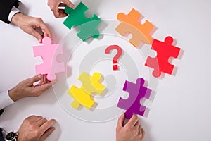 Group Of Businesspeople Holding Jigsaw Puzzle