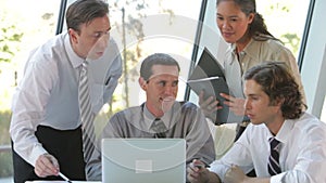 Group Of Businesspeople With Laptop Having Meeting