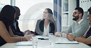 Group of businesspeople laughing and smiling together after planning an innovation project in a collaboration meeting in