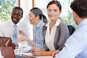 Group Of Businesspeople Meeting Around Boardroom Table