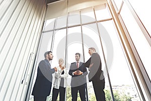 Group of businesspeople meeting talking together in office, brainstorming conference.