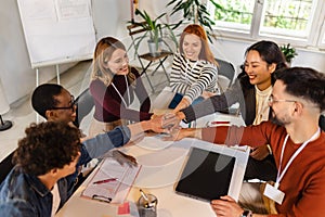 Businesspeople stacking their hands on top of each other