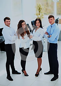 Group of businesspeople standing together in office.